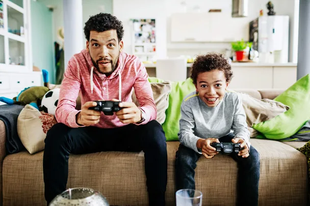 father and son playing video games